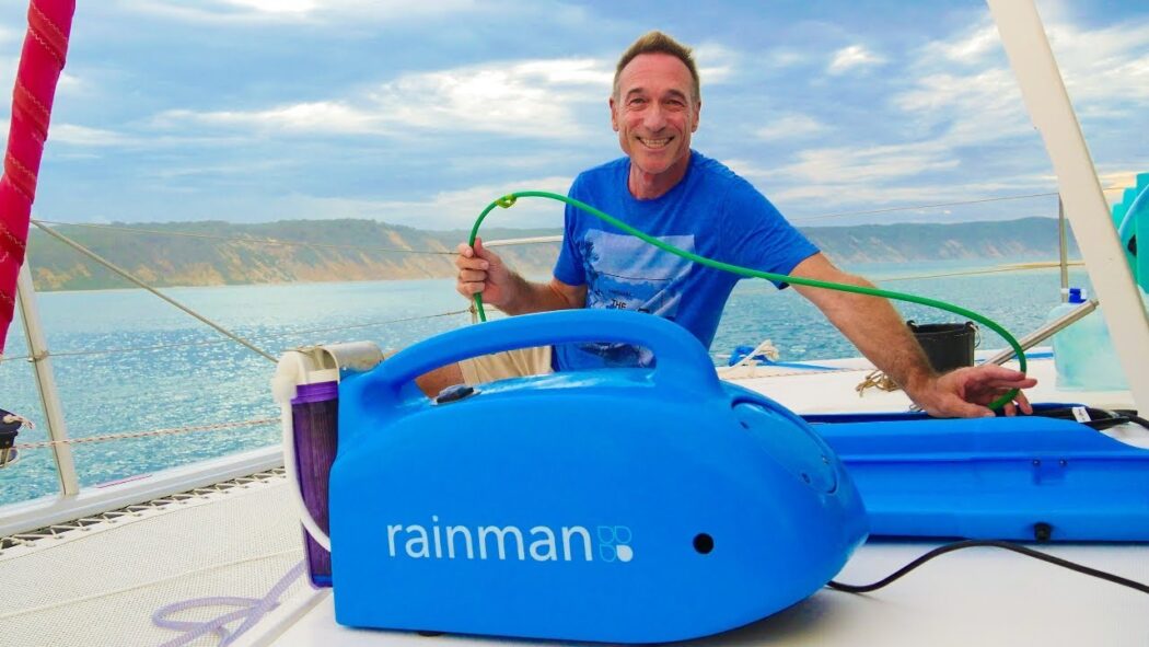 Man sitting next to Sailboat Watermakers