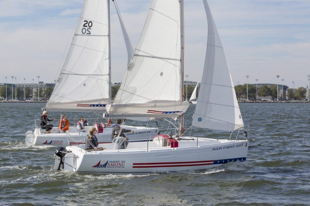 Two sailboats on the waves