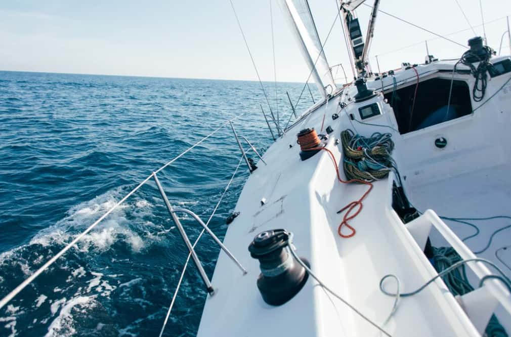 View from the deck of a sailing yacht cruising on open blue waters